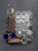 A tray containing assorted glassware to include an antique etched glass beaker,