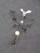 A cast iron weather vane surmounted by an eagle.