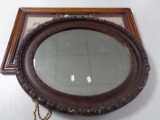 An antique oval composite framed mirror together with a further framed antique mirror with two