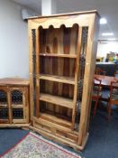 A set of sheesham wood bookshelves fitted drawer beneath