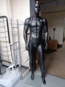 A male shop mannequin on stand (black).