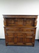 An Edwardian carved oak court cupboard