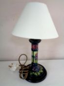 A Moorcroft table lamp, violets, on green ground, on wooden base,