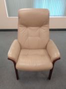 A late 20th century beige leather high backed armchair.