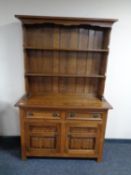A good quality oak double door Welsh dresser, fitted two drawers.