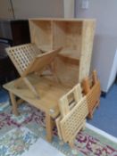 A square pine coffee table together with a set of pine cube shelves,