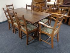 An oak refectory dining table and set of six ladder back chairs