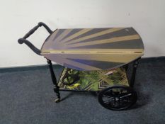 A tea trolley painted in Art Deco style.