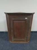 An early 19th century hanging corner cupboard