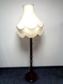 A stained beech standard lamp with shade
