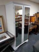 A painted Ducal pine double door mirrored wardrobe