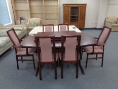 A 20th century Stouby twin pedestal extending dining table with two leaves and six chairs,