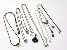 Five silver pendants/necklaces.