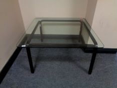 A contemporary glass topped coffee table.