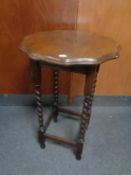 A shaped Edwardian oak barley twist occasional table