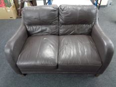 A brown leather two seater settee