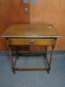 An Edwardian oak barley twist occasional table fitted a drawer