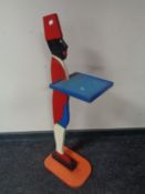 A painted figural dumb waiter