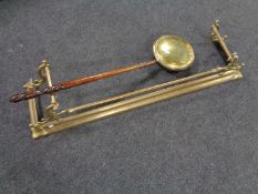 A brass Art Nouveau fire curb together with a brass wooden handled bed warming pan.