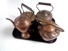 Three antique copper kettles together with a copper teapot.