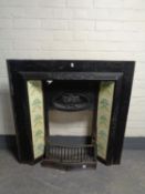 An antique cast iron fire insert with tiles (a/f)