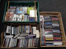 A box and two crates containing assorted DVDs and CDs.