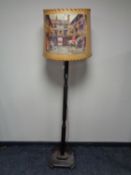 An early 20th century standard lamp with shade depicting a hunting scene.