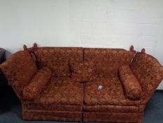 A contemporary drop end sette upholstered in a red floral fabric