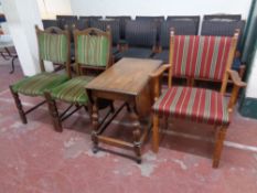 A continental oak armchair upholstered in a striped fabric together with a further pair of oak