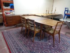 A mid 20th century teak McIntosh furniture eight piece dining room suite comprising of triple door