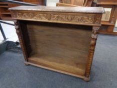 A set of early 20th century profusely carved oak open bookshelves, fitted two drawers above.