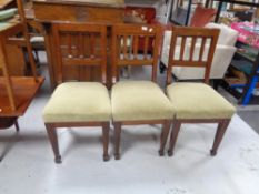 A set of three antique mahogany rail backed dining chairs