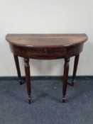 An Eastern hardwood D-shaped table, fitted a drawer.