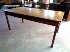 A mid 20th century Danish teak office table fitted slide and three drawers