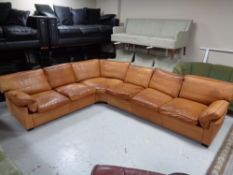 A 20th century Danish brown leather six seater corner settee.