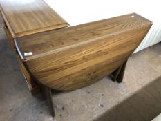 An Ercol elm drop leaf table