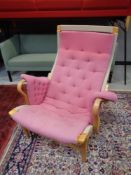 A beech framed high back 'Pernilla' armchair by Bruno Mathsson for Dux, upholstered in pink fabric.