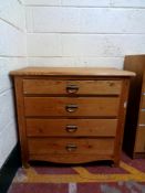 An antique pine four drawer chest