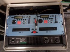 A DJ's flight case containing a QSC Powerlight 20 professional amplifier,