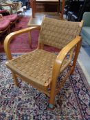 A 20th century beech framed rush upholstered armchair.