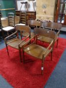A set of four mid 20th century Danish stained beech armchairs.