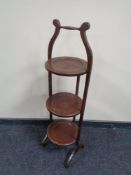An early 20th century mahogany three tier folding cake stand.