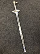 A good quality reproduction broad sword mounted in brass with scabbard, total length 117 cm.