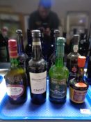 A tray containing eight bottles of alcohol to include Croft Port, Harvey's Bristol Cream,