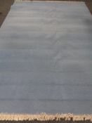 A contemporary fringed carpet on blue ground 405 x 278 cm