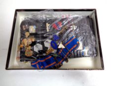 A box containing a collection of enamelled pin badges
