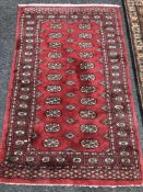 An Afghan Tekke rug on red ground 152 x 95 cm