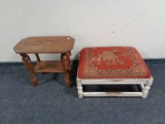 An Indian heavily carved occasional table and an upholsterd footstool