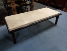 A contemporary rectangular coffee table with inset marble top