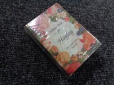 Seven boxes containing a quantity of new personalised address books bearing different names